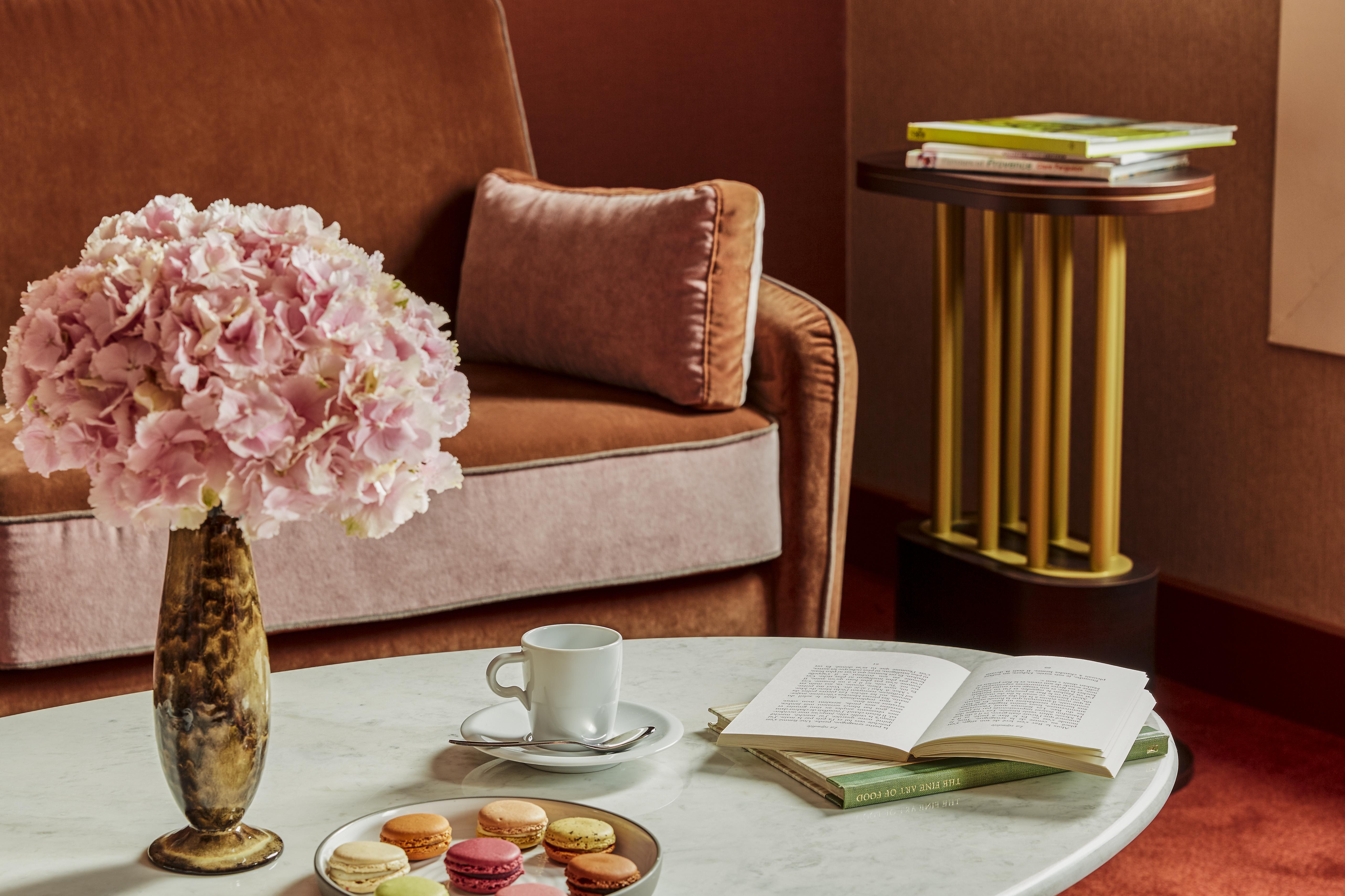 Nest Paris La Defense - Mgallery Puteaux Dış mekan fotoğraf A table with a coffee cup and saucer, a book, and a vase of flowers